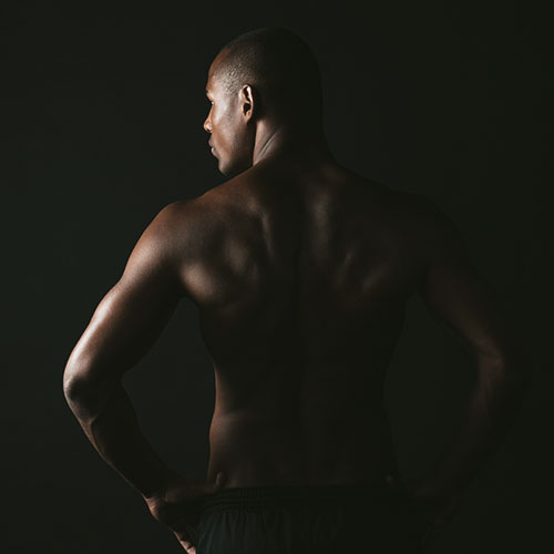 a
                                                                                                      dark
                                                                                                      skinned
                                                                                                      man
                                                                                                      shirtless
                                                                                                      on
                                                                                                      a
                                                                                                      dark
                                                                                                      background
                                                                                                      looking
                                                                                                      away
                                                                                                      from
                                                                                                      the
                                                                                                      camera
                                                                                                      after
                                                                                                      having
                                                                                                      a
                                                                                                      full
                                                                                                      back
                                                                                                      and
                                                                                                      shoulder
                                                                                                      wax